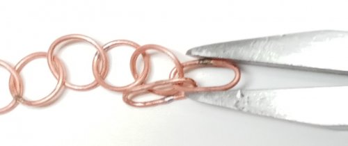 Judy Larson's Make a Soldered Paperclip Chain - , Contemporary Wire Jewelry, Making Chain, Chain Making , Coiling, Coiling Wire, Wire Coiling, Butane Torch, Soldering, Solder, First squeeze one end slightly